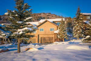 Chalet / cabin with board and batten siding and a garage