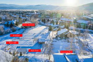 Snowy aerial view featuring a mountain view