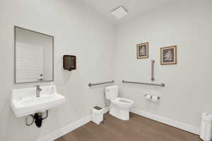 Bathroom with toilet and dark wood finished floors
