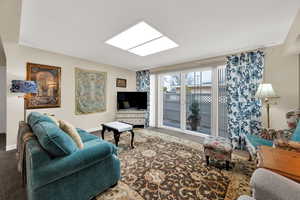 Living area with carpet flooring and baseboards