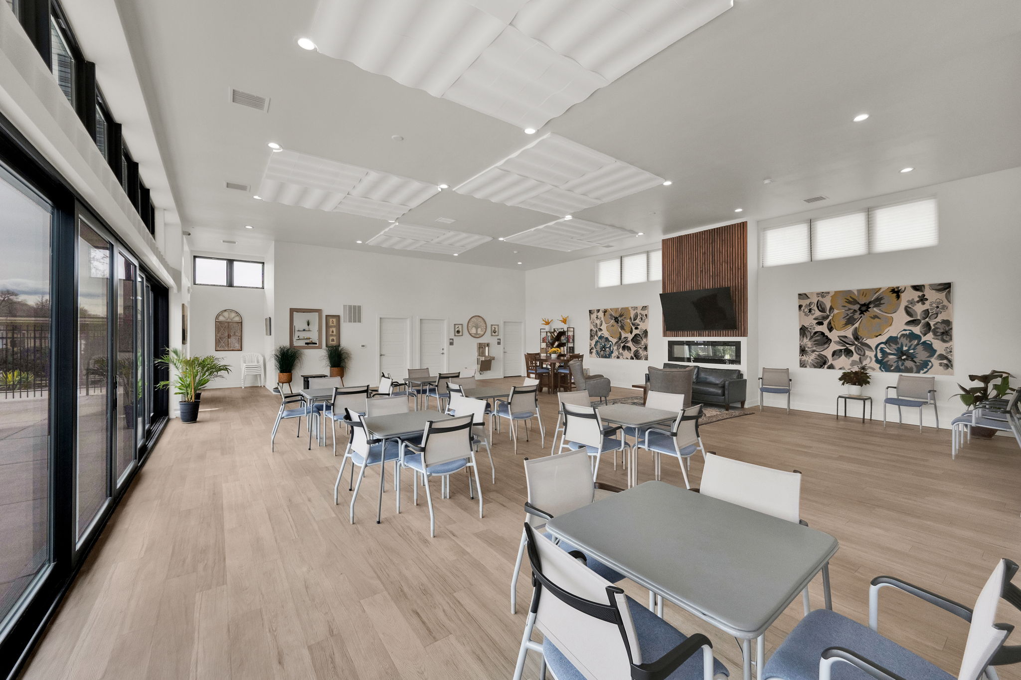 Dining room featuring light wood-style floors, a high ceiling, and recessed lighting