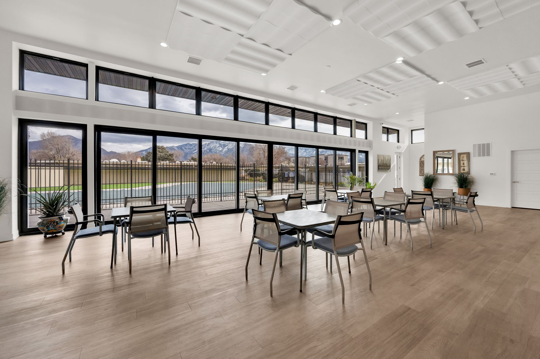 Dining room featuring a mountain view, a high ceiling, light wood-style floors, and recessed lighting
