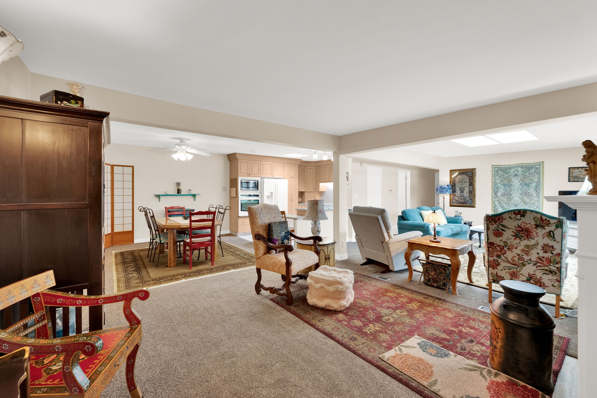 Living room with light colored carpet and a ceiling fan
