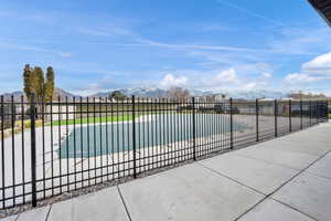 View of pool featuring patio surround and a mountain view