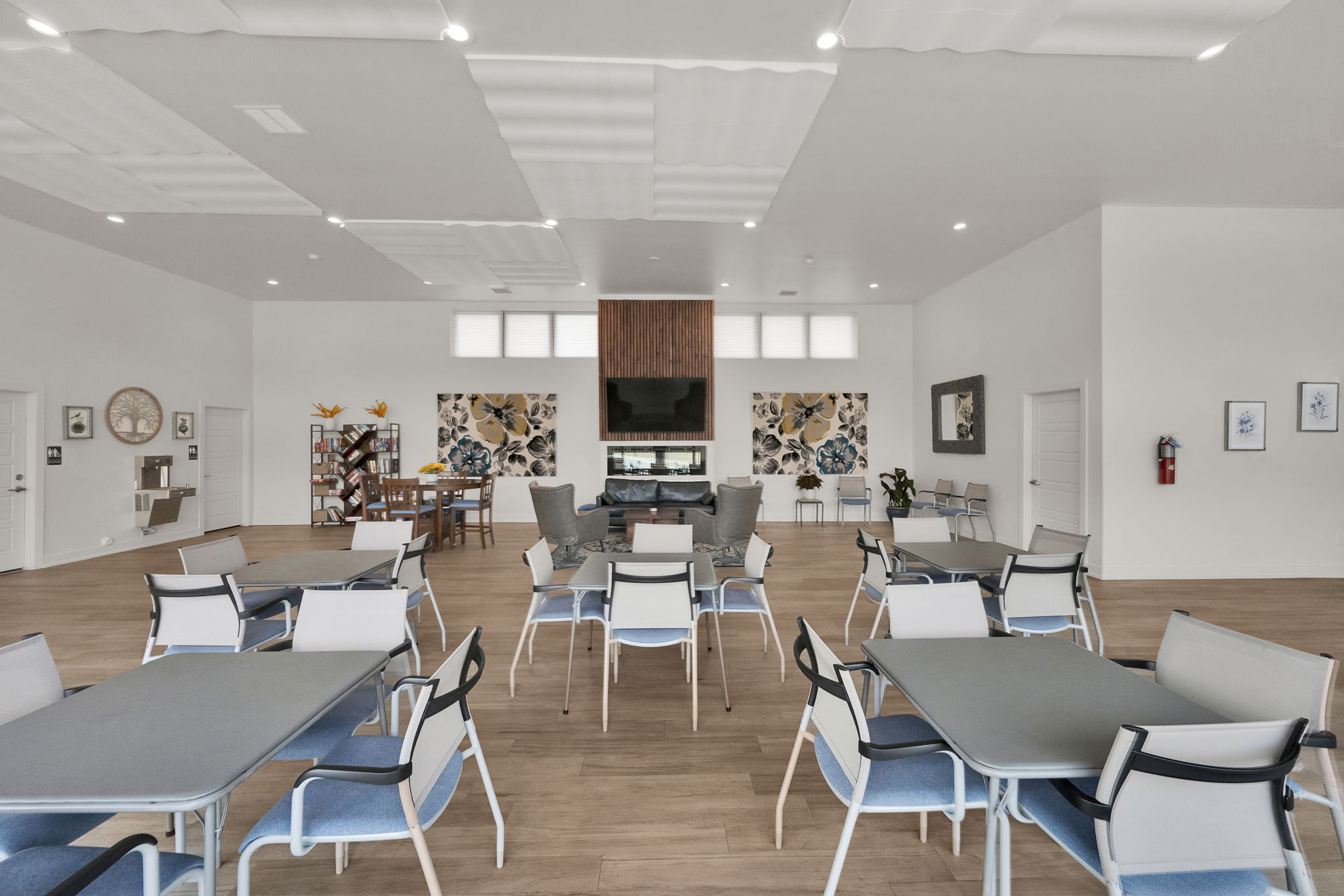 Dining room with light wood finished floors, a high ceiling, and recessed lighting