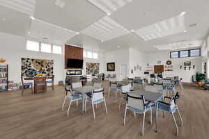 Dining space featuring a high ceiling and light wood finished floors