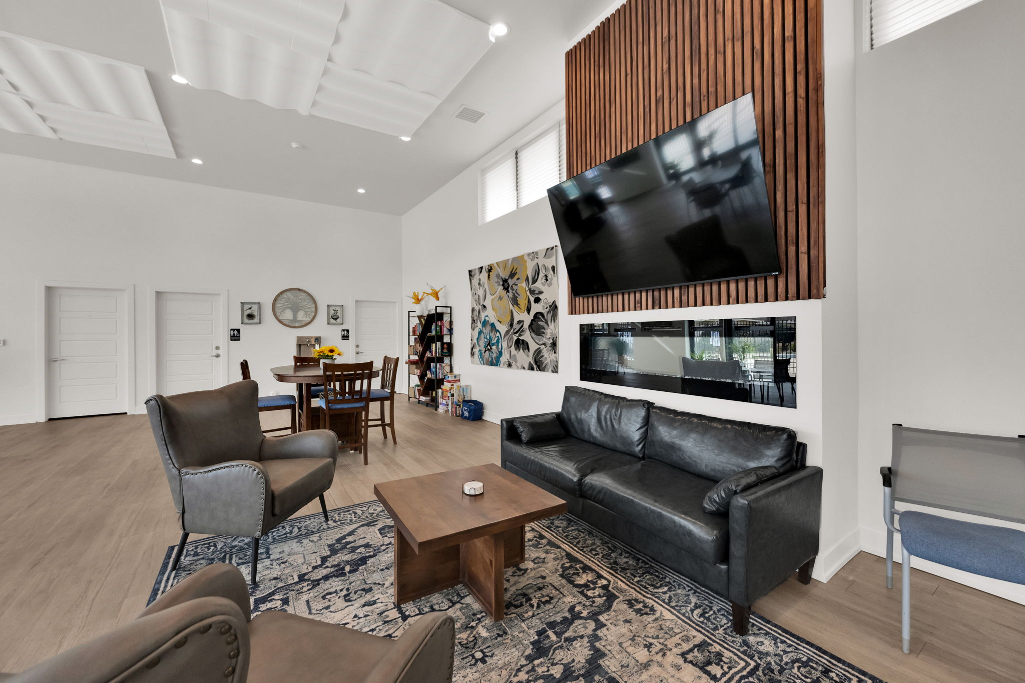 Living room featuring a high ceiling, wood finished floors, and recessed lighting