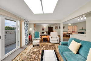 Living area with carpet flooring and a ceiling fan