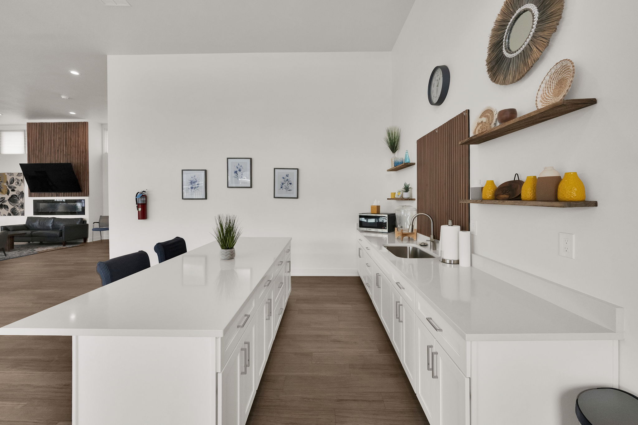 Kitchen with a breakfast bar area, dark wood-style floors, open shelves, white cabinets, and recessed lighting