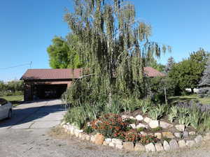 View of front of house featuring a metal roof, driveway, and an attached garage