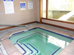 View of swimming pool with an in-ground hot tub