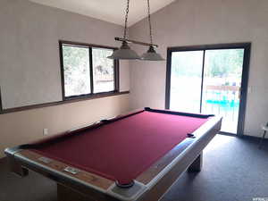 Rec room featuring lofted ceiling, carpet, and pool table