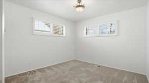 Spare room with carpet and baseboards
