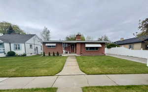 Brick exterior residence with a concrete walkway and driveway