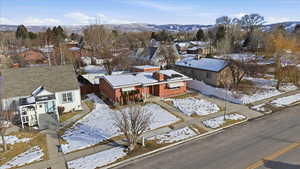 Snowy aerial view featuring a residential view and a mountain view