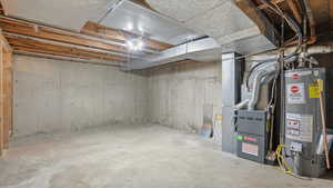 Unfinished below grade area with water heater and heating unit