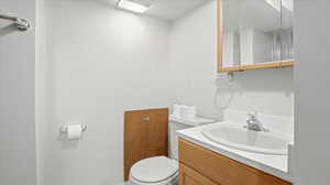 Half bath featuring vanity and toilet