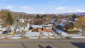 Snowy aerial view with a residential view and a mountain view