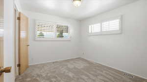 Unfurnished bedroom with carpet floors and baseboards