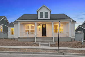 Bungalow-style home featuring a porch, board and batten siding, and roof with shingles