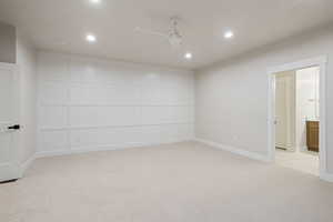Empty room with ceiling fan, light colored carpet, and recessed lighting