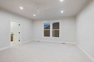 Spare room with light colored carpet, a ceiling fan, and recessed lighting