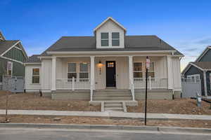 Bungalow featuring board and batten siding, covered porch, and roof with shingles