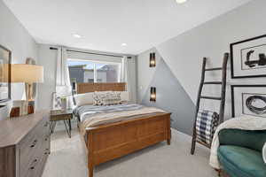 Bedroom featuring light carpet and recessed lighting