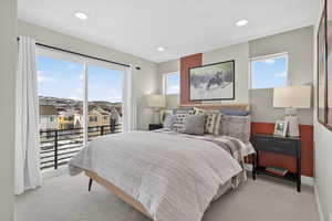 Bedroom with access to outside, light carpet, and recessed lighting