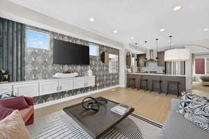 Living room featuring light wood-type flooring and recessed lighting