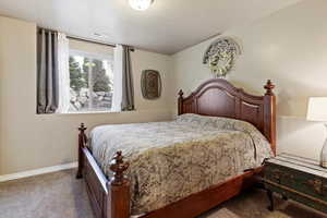 Carpeted bedroom featuring baseboards
