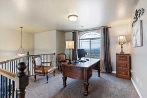 Carpeted office with baseboards
