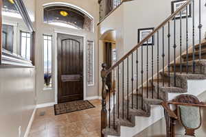 Entryway featuring arched walkways and a high ceiling