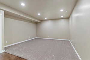 Finished below grade area with recessed lighting and light carpet