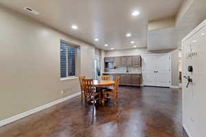 Dining area with concrete floors and recessed lighting