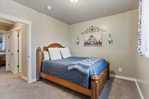 Bedroom featuring baseboards and carpet flooring
