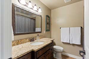 Bathroom featuring vanity, a shower with shower curtain, and dark tile patterned floors