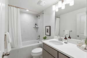 Full bathroom featuring vanity and a combined bath / shower with marble appearance