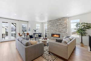 Living room featuring light wood-style floors and a fireplace