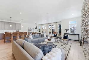 Living area featuring light wood-style floors and recessed lighting