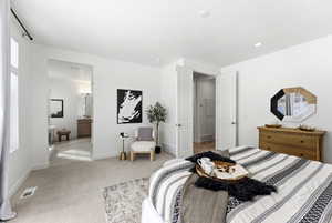 Bedroom with carpet floors and ensuite bath