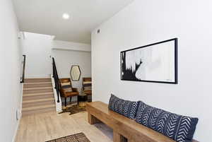 Hall featuring light wood-type flooring and recessed lighting
