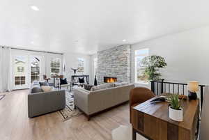 Living room with light wood-style flooring and a fireplace