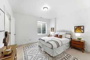 Bedroom with light carpet and a textured ceiling