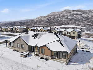 Snowy aerial view with a residential view and a mountain view