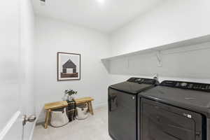 Laundry room with washer and dryer and baseboards