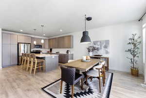 Dining space featuring light wood-type flooring and recessed lighting
