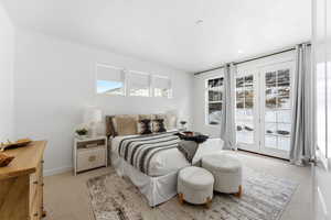 Bedroom featuring light colored carpet and access to exterior