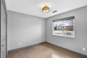 Spare room featuring baseboards and light wood-style floors