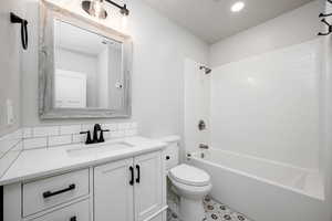 Full bath featuring vanity, shower / washtub combination, and recessed lighting